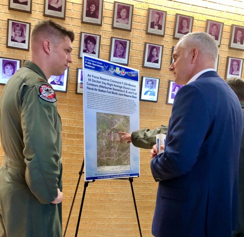 Maj. Matthew Strongin 301st Fighter Wing F-35 Program Integration Office director of operations speaks with a local citizen prior to the wing's F-35A Public Hearing event at Brewer High School Auditorium, Fort Worth, Texas on March 5. The public’s input is valuable and assists the Air Force in making informed decisions and comments on the Draft EIS can be provided verbally at the public hearing, submitted electronically, or in writing. (U.S. Air Force photo by Julie Briden-Garcia)