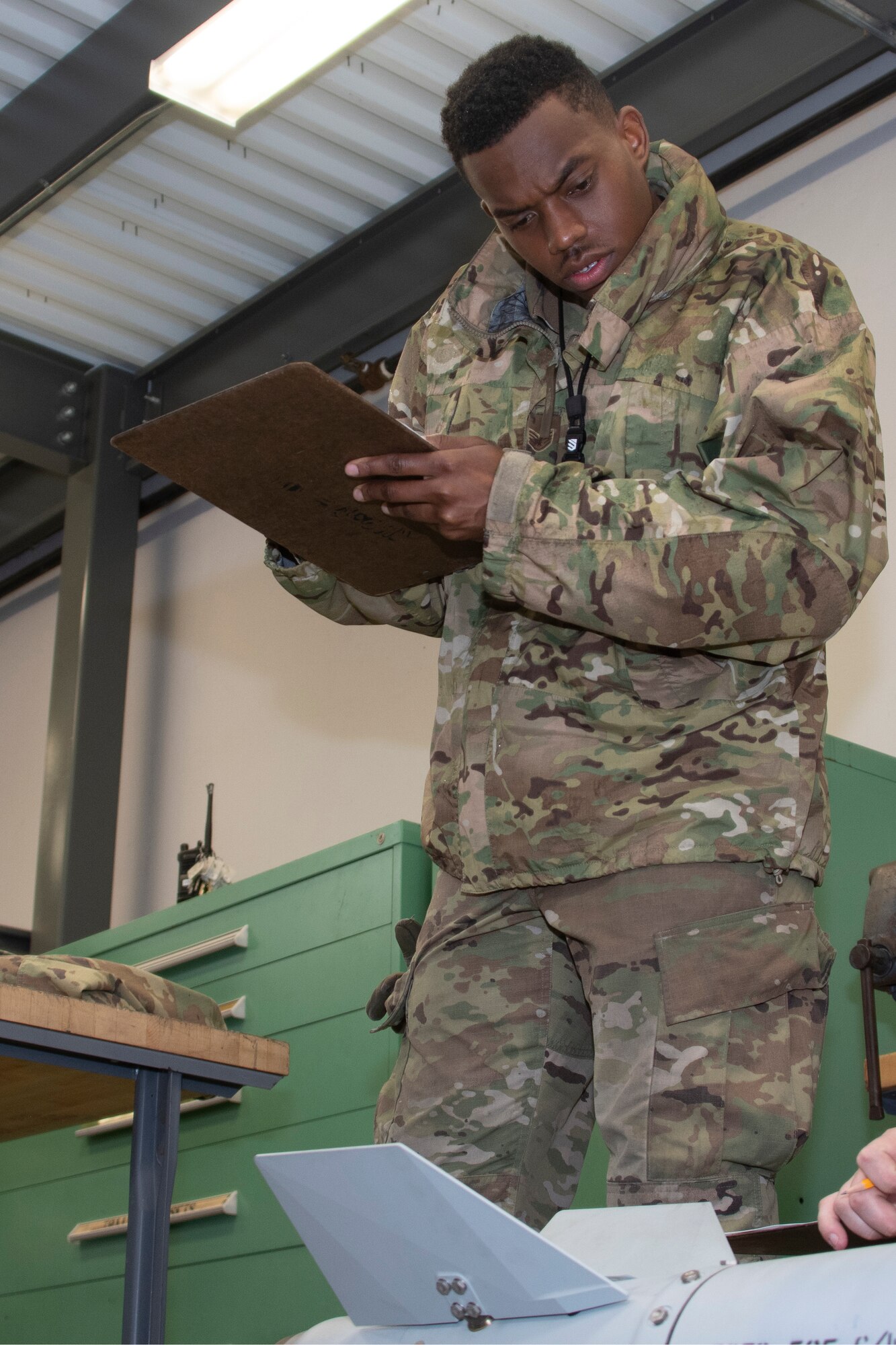 Photo of Airman checking munitions.