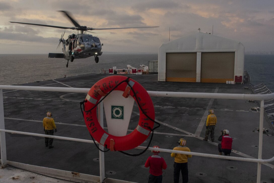 A helicopter lands on USNS Mercy.