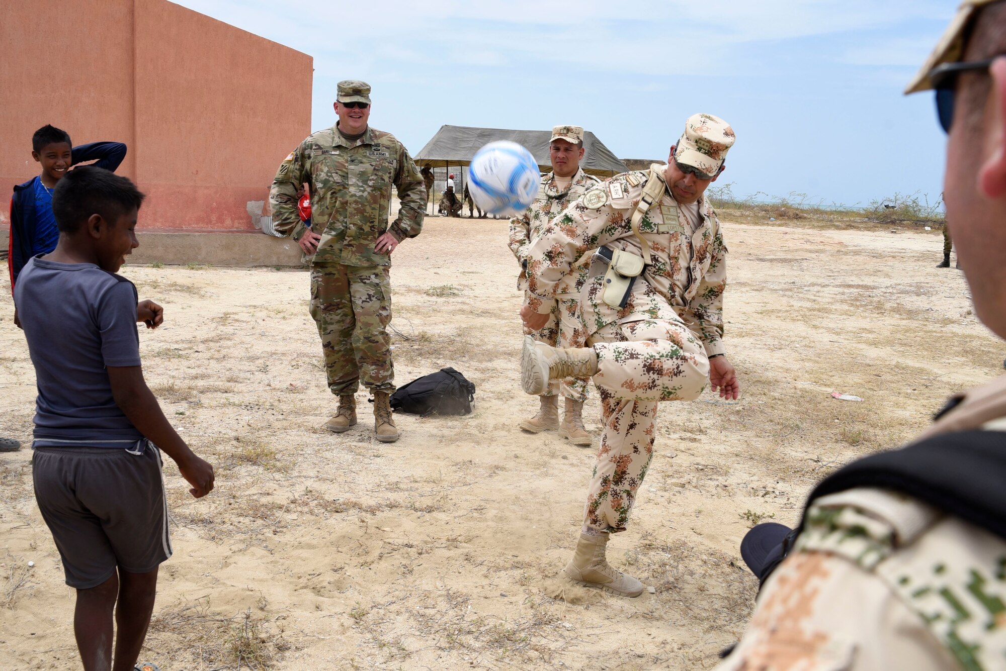 Colombian Army Maj. Gen. Hugo Lopez Barreto, senior commander for Exercise Vita, kicks a soccer ball with local children during a medical readiness exercise in Carrizal, Colombia, March 11, 2020. Exercise Vita brought combined forces together to perform humanitarian and civic-action operations in the La Guajira region of Colombia. Medical readiness exercises prepare participants for future operations while providing key services to communities most in need. (U.S. Army photo by Lt. Col. Laura Miller)