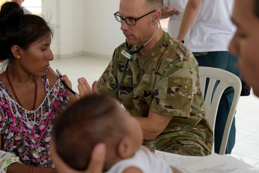 U.S. Army Maj. Scott Robison, critical care nurse, examines a local woman during a medical readiness event as part of Exercise Vita in Carrizal, Colombia, March 11, 2020. Exercise Vita brought combined U.S. and Colombian forces together to perform humanitarian and civic-action operations in the La Guajira region of Colombia. Medical readiness exercises prepare participants for future operations while providing key services to communities most in need. (U.S. Air Force photo by Tech. Sgt. Daniel Owen)
