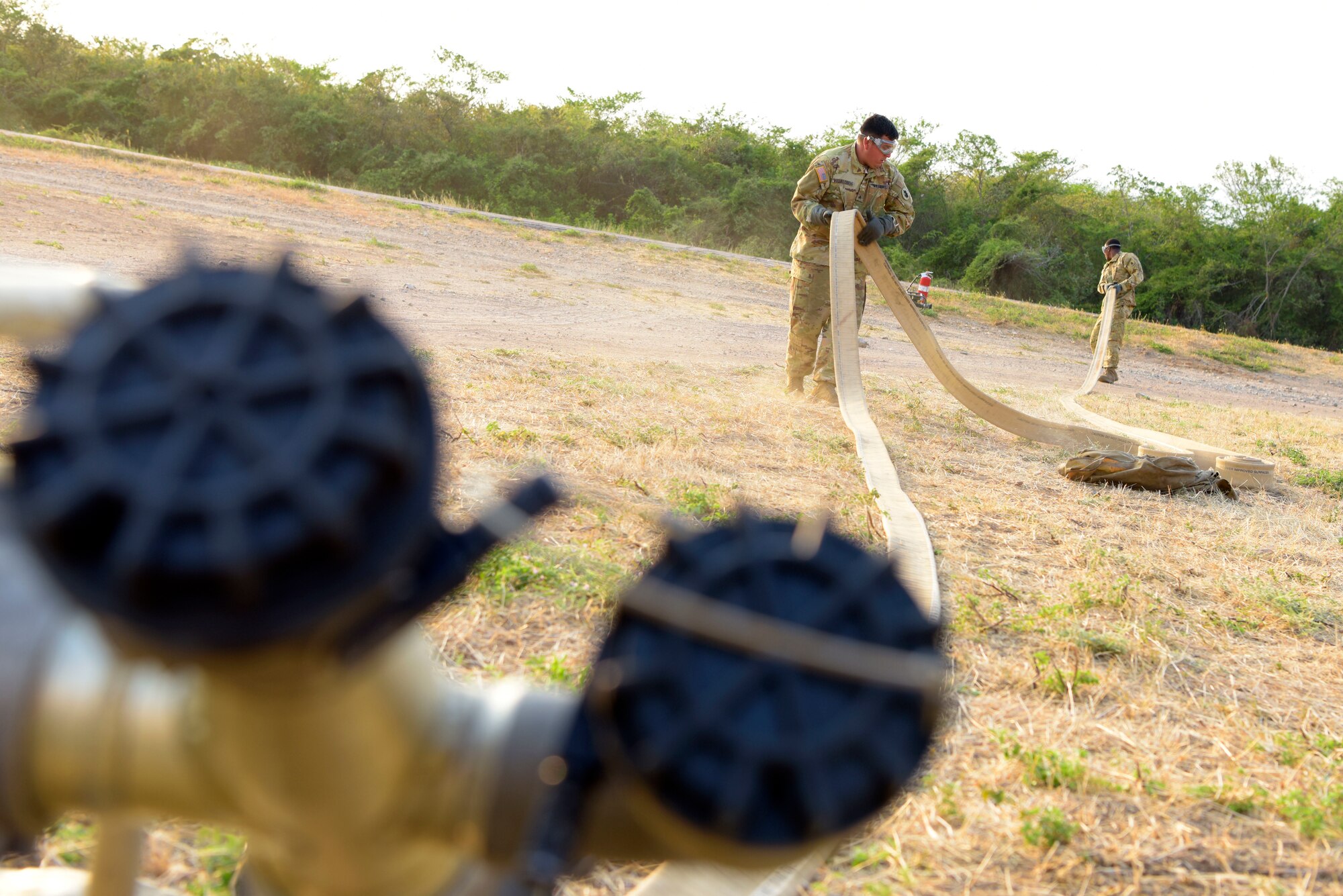 Two Soldiers with the 1st Battalion, 228th Aviation Regiment establish a remote fuel line for to supply helicopters as part of Exercise Vita at Fort Buenavista, Colombia, March 7, 2020. Exercise Vita brought U.S. and Colombian forces together to perform humanitarian and civic-action operations. The exercise focuses on reinforcing longstanding ties and enhancing participants’ overall readiness while demonstrating U.S. Southern Command’s enduring promise to the Americas. (U.S. Air Force photo by Tech. Sgt. Daniel Owen)