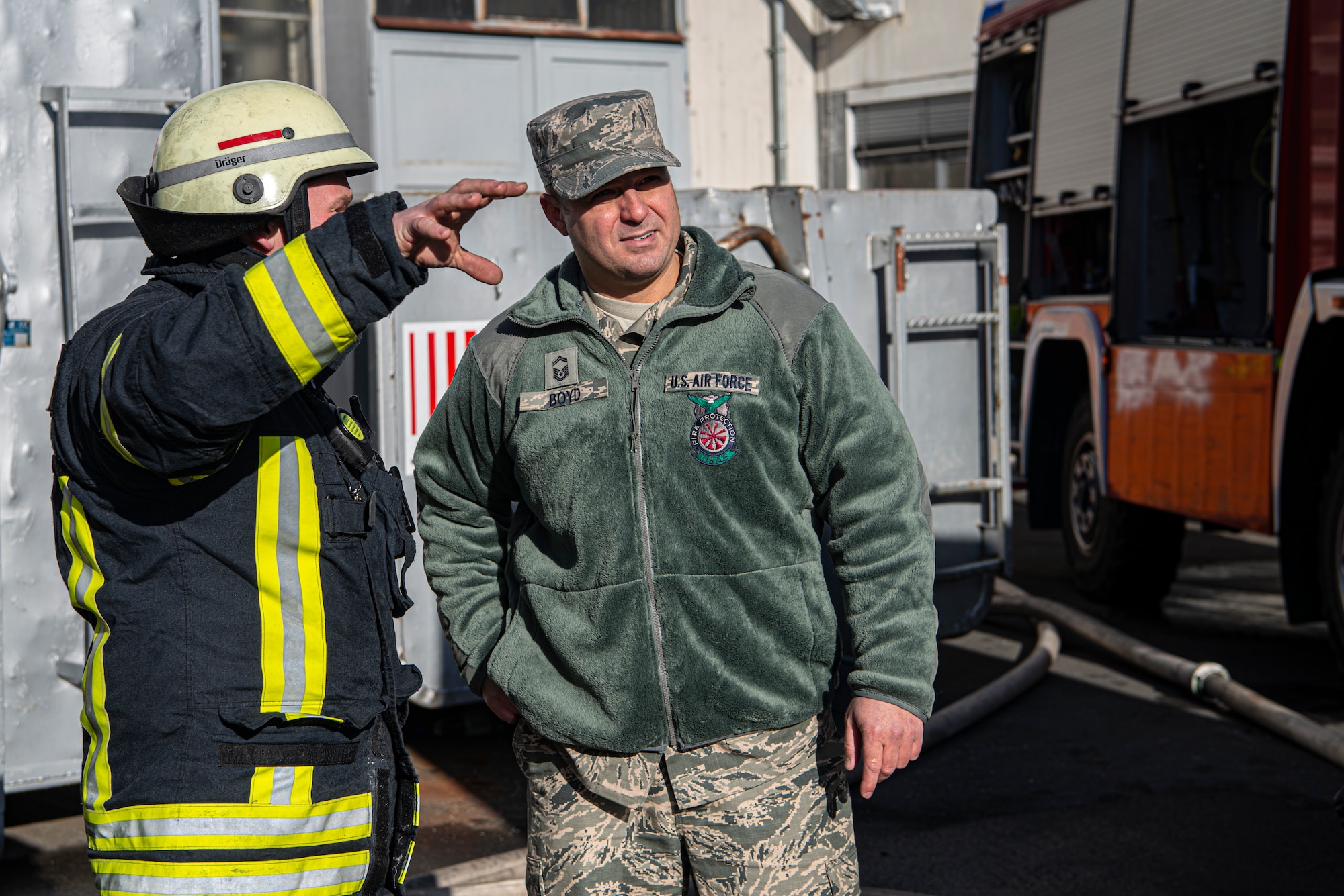 U.S. Air Force Senior Master Sgt. Jordan Boyd, 86th Civil Engineer Squadron Fire and Emergencies deputy fire chief, speaks with a German firefighter on-scene in Otterberg, Germany, March 23, 2020.