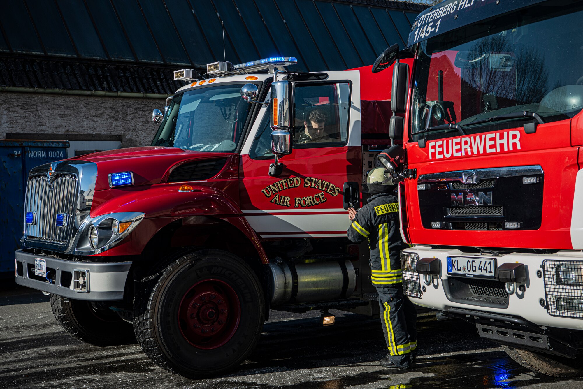 U.S. Air Force Airman 1st Class Jackson Bird, 86th Civil Engineer Fire and Emergencies firefighter, speaks with his German counterpart in Otterberg, Germany, March 23, 2020.