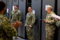 JOINT BASE LANGLEY-EUSTIS, Va. (March 23, 2020) Navy Logistics Specialist 1st Class Zachary Smith, center, is promoted by Joint Task Force Civil Support Commanding General Maj. Gen. William “Bill” Hall during a ceremony in the command’s mobility center.