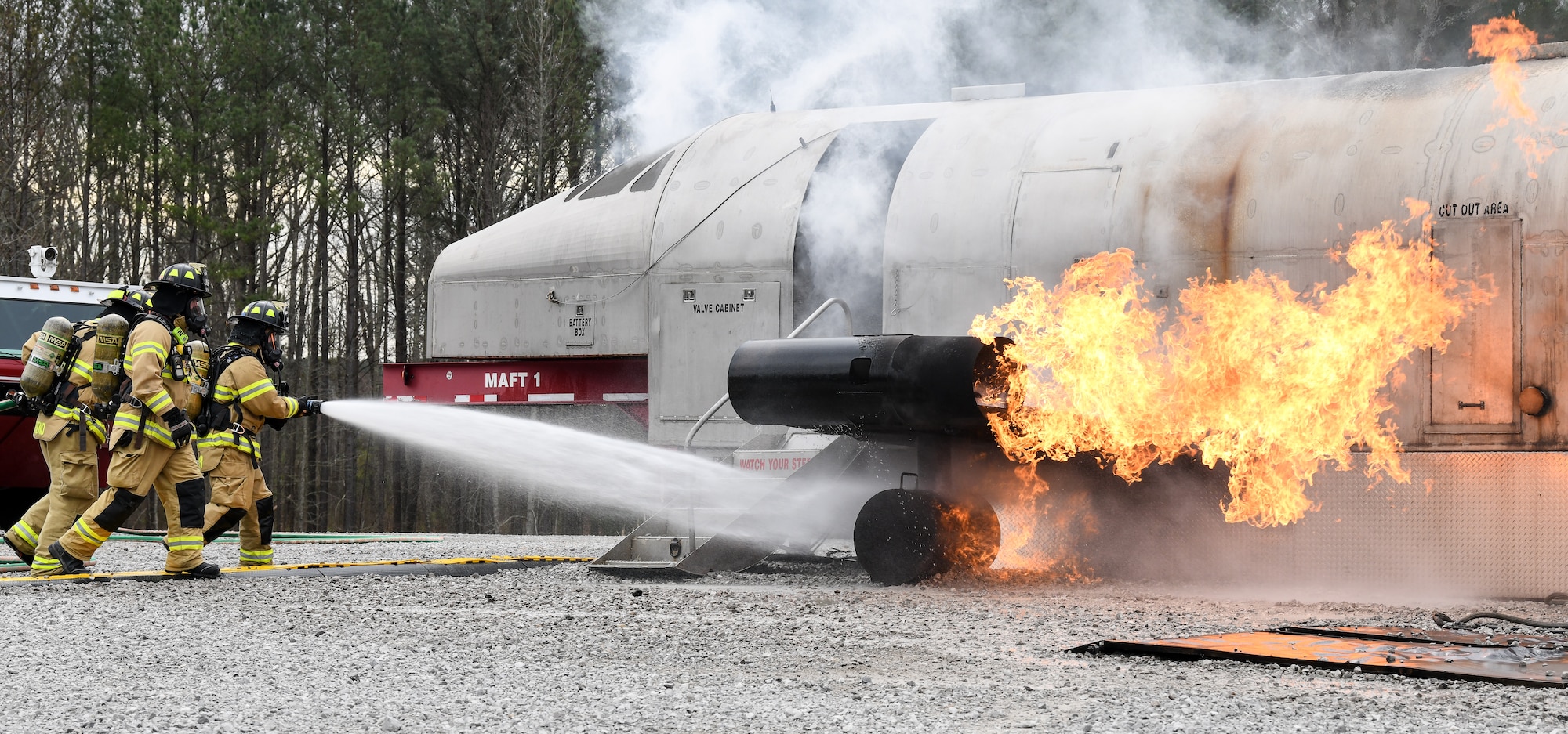 Arnold Air Force Base Fire and Emergency Services personnel attack an aircraft fire with a hand line as they train, March 5, 2020, on aircraft rescue and firefighting techniques using a propane-fueled trainer brought to the base. The aircraft trainer can simulate fires in multiple locations - cabin, ground, engine, wheel and brake, and the auxiliary power unit. (U.S. Air Force photo by Jill Pickett)
