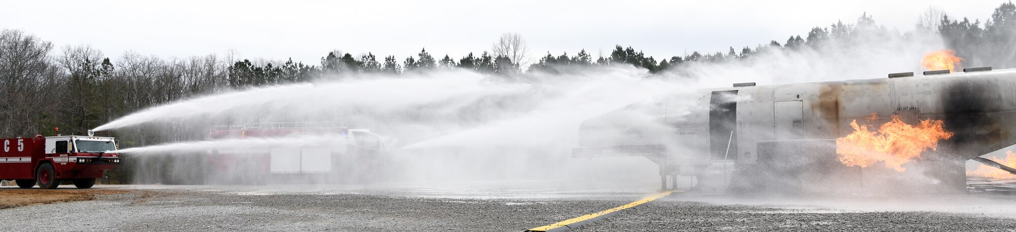 While training, March 5, 2020, on aircraft rescue and firefighting techniques at a training area on base, Arnold Air Force Base Fire and Emergency Services personnel use aircraft fighting vehicle-mounted nozzles to battle a blaze. (U.S. Air Force photo by Jill Pickett)