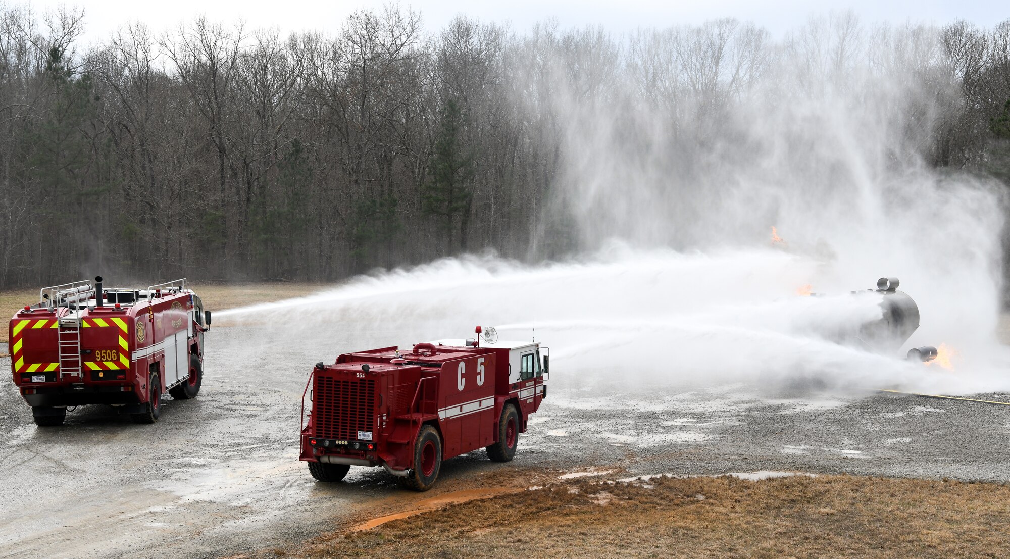 Arnold Air Force Base Fire and Emergency Services personnel attack a fire using vehicle-mounted nozzles while training March 5, 2020, on aircraft rescue and firefighting techniques at a training area on base. (U.S. Air Force photo by Jill Pickett)