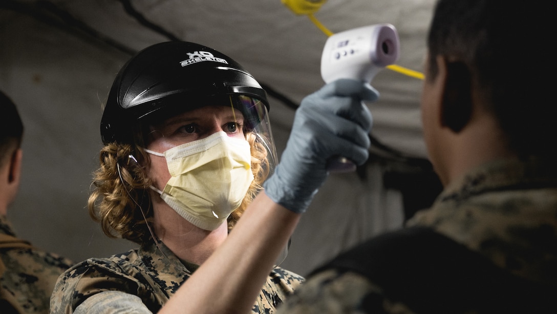 A U.S. Navy Hospital Corpsman pre-screens Marines for the coronavirus disease after their return from a deployment overseas on Marine Corps Air Station Cherry Point, N.C., March 24.