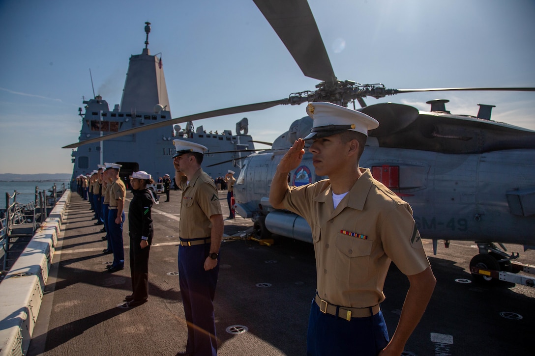 U.S. Marines and Sailors salute as they man the rails of the USS Somerset (LPD-25) during San Francisco Fleet Week's Parade of Ships on Oct. 11.