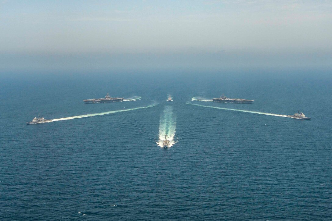 Six ships sail in formation.