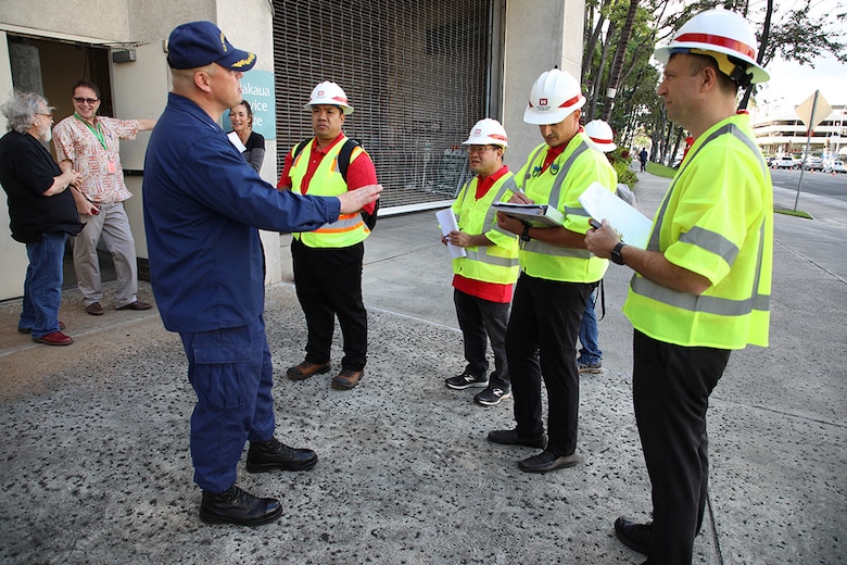 A U.S. Army Corps of Engineers (USACE) technical survey team listens to U.S. Public Health Service Capt. Erik Vincent, strategic planning liaison for U.S. INDO-PACOM, discuss potential roadway access to the Hawaii Convention Center during a site assessment, March 23.