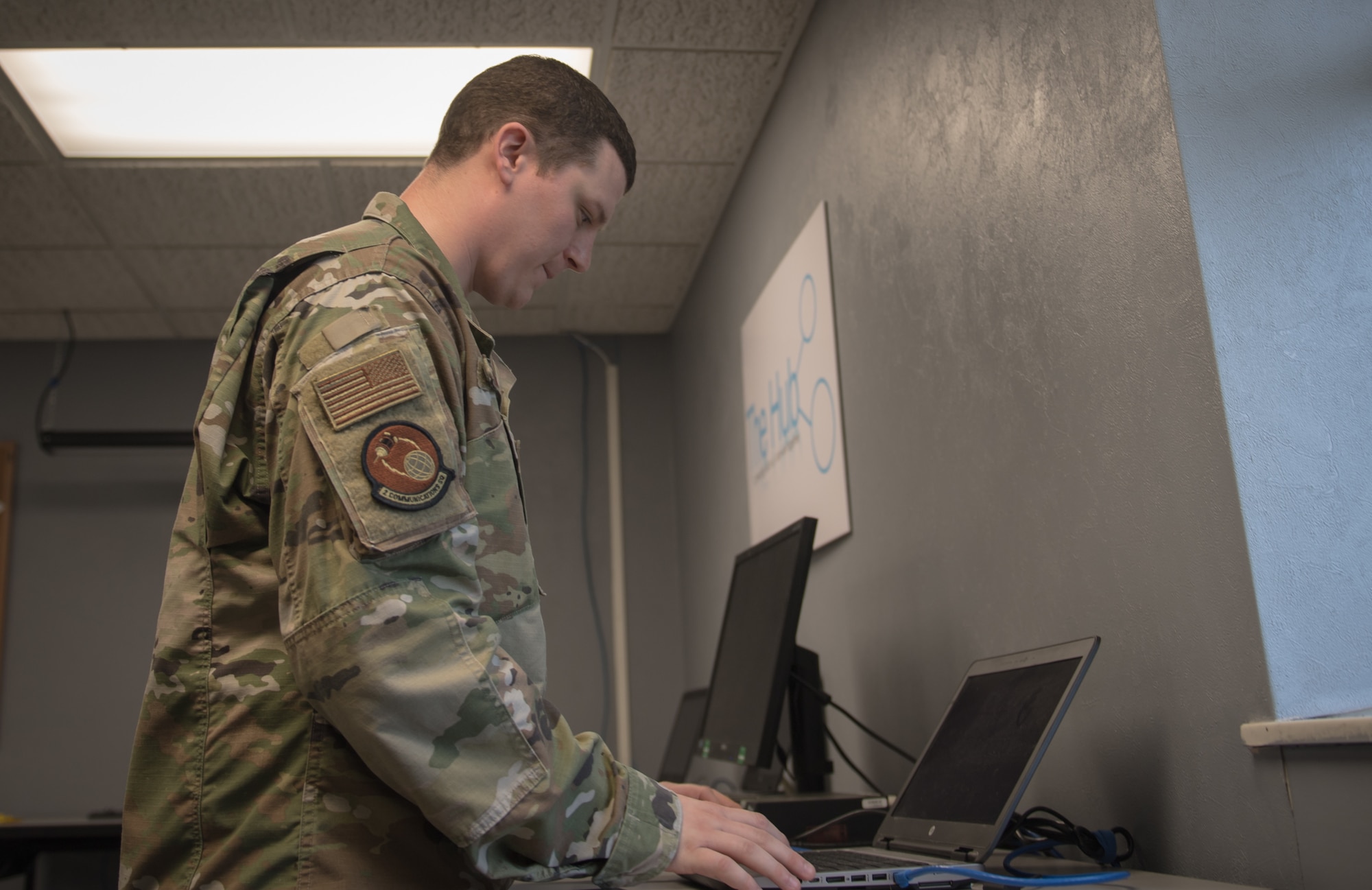 Tech. Sgt. Jessica Oliver, 2nd Communications Squadron base equipment control office NCO-in-charge, looks over an inventory of laptops ready for customer use at  Barksdale Air Force Base, La., March 20, 2020. To meet the surge of teleworking personnel, the 2nd CS expanded operations of "The Hub," a walk-in computer clinic, by repurposing a conference room as a laptop porting station. (U.S. Air Force photo by Tech. Sgt. Daniel Martinez)