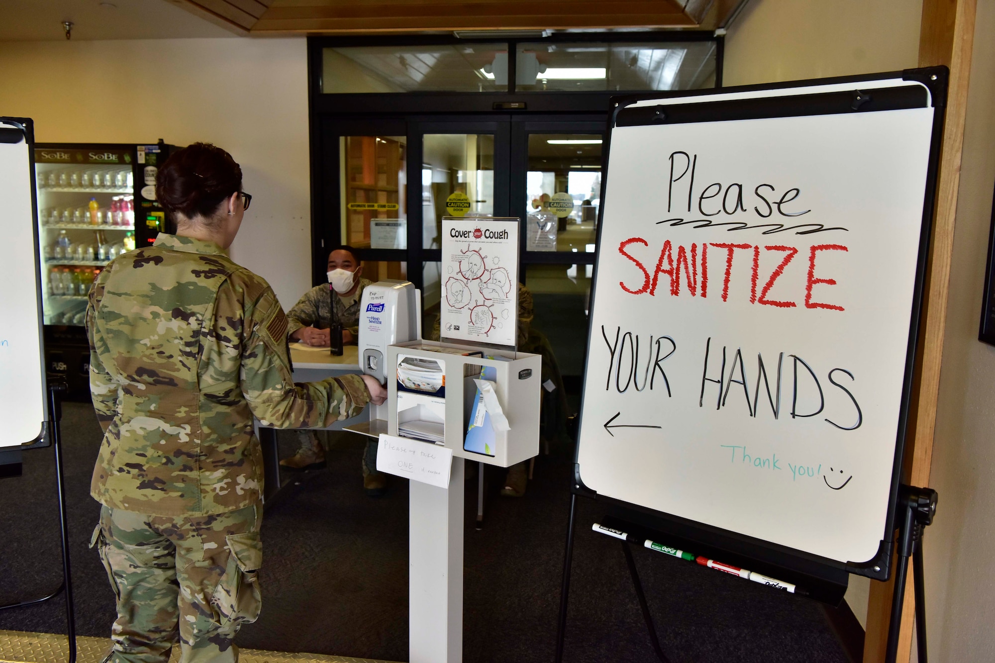 A 354th Medical Group Airman sanitizes her hands before entering the clinic on Eielson Air Force Base, Alaska, March 20, 2020. The 354th MDG has taken extra precautions to help stop the spread of the novel coronavirus including implementing a patient screening checkpoint at the clinic entrance. (U.S. Air Force photo by Senior Airman Beaux Hebert)