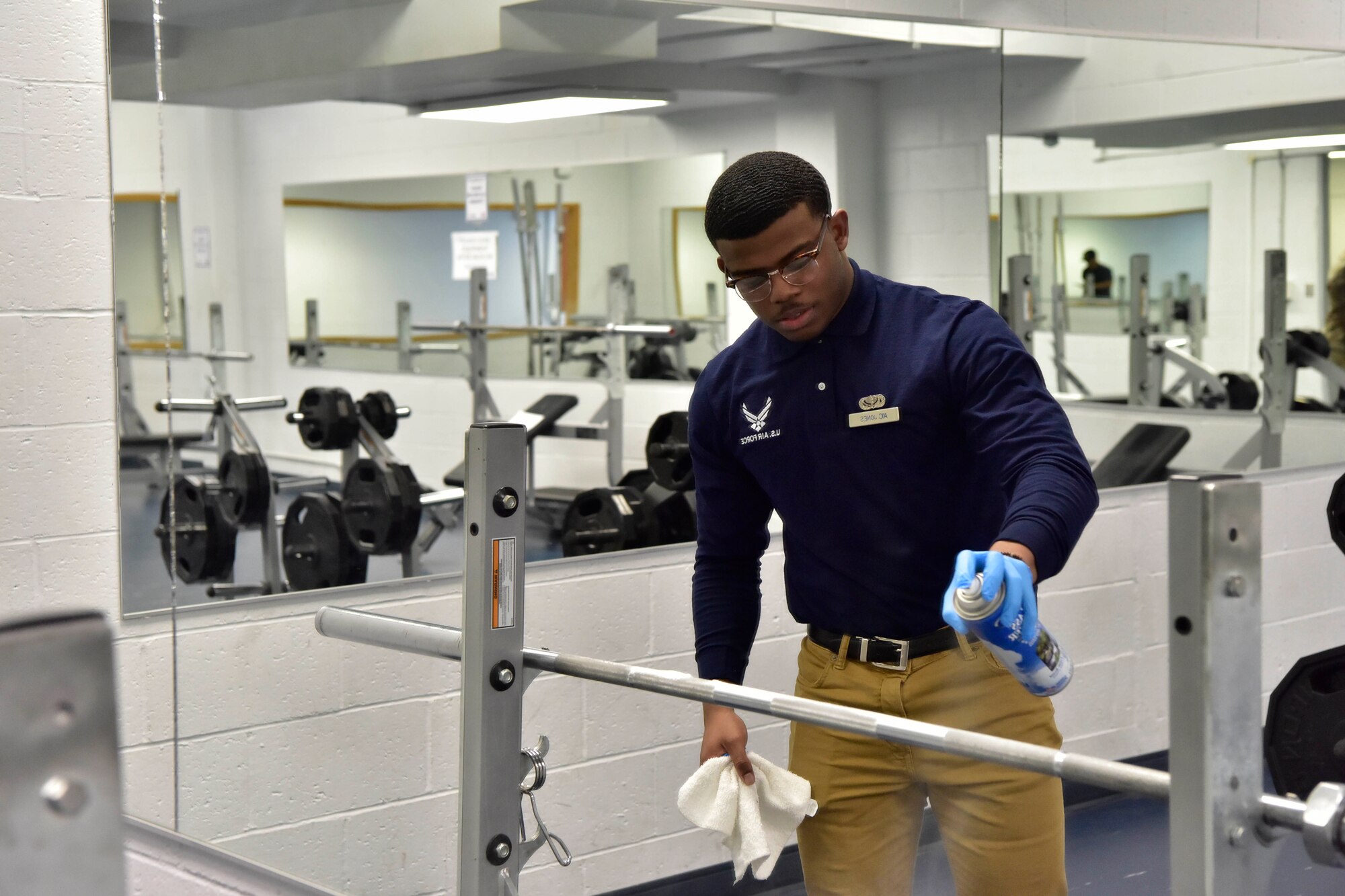 A 354th Force Support Squadron Airman sanitizes gym equipment at the Baker Fieldhouse on Eielson Air Force Base, Alaska, March 20, 2020. Fitness is a vital part of a healthy lifestyle and in the midst of the COVID-19 pandemic, the 354th FSS is taking extra precautions to ensure equipment is sanitized and clean around the clock. (U.S. Air Force photo by Senior Airman Beaux Hebert)