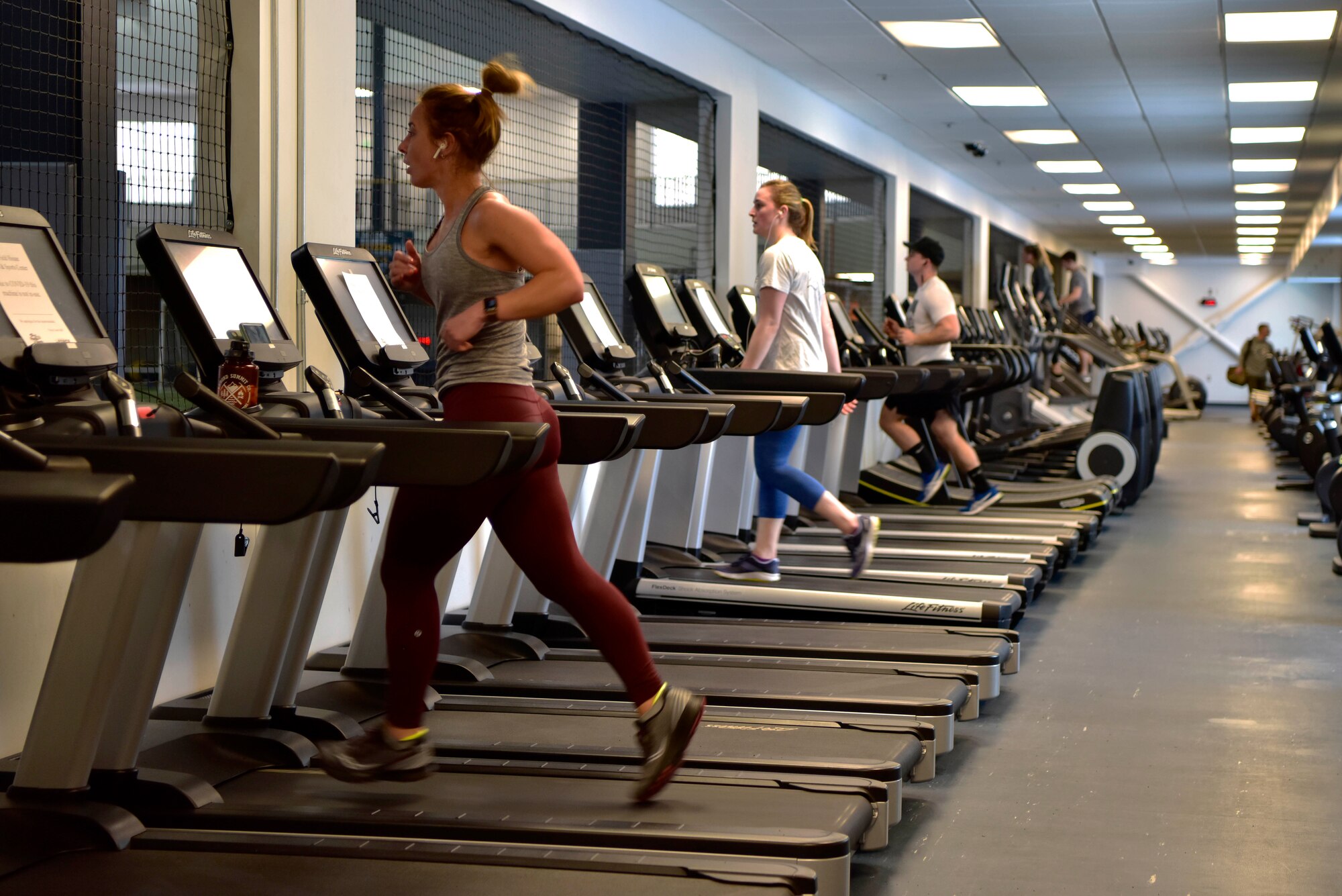 Airmen assigned to the 354th Fighter Wing run on treadmills in the Baker Fieldhouse on Eielson Air Force Base, Alaska, March 21, 2020. In light of the Department of Defense policy prohibiting group physical training the wing is enforcing social distancing at the gym by limiting the number of work out machines available for use. (U.S. Air Force photo by Senior Airman Beaux Hebert)