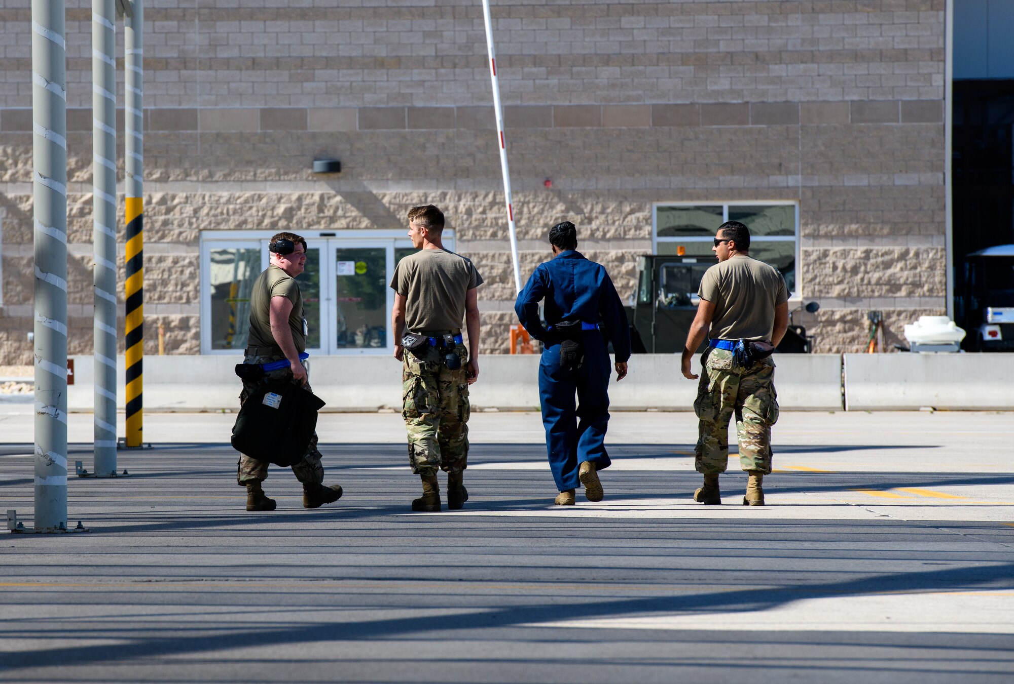 Maintainers from the 62nd Aircraft Maintenance Unit, walk on the flightline March 23, 2020, at Luke Air Force Base, Ariz.