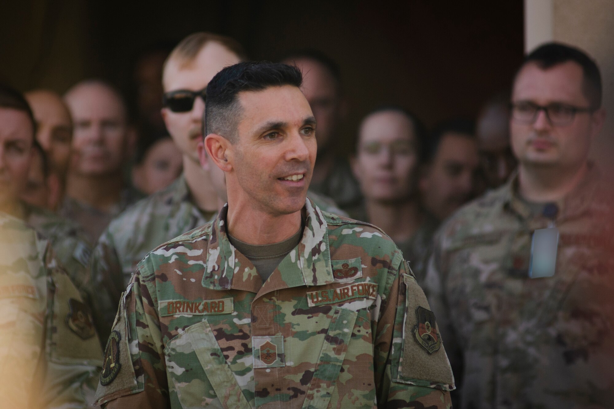 U.S. Air Force Chief Master Sgt. Shawn Drinkard, U.S. Air Forces Central Command command chief, speaks with AFCENT Airmen outside of the combined air operations center at Al Udeid Air Base, Qatar, March 6, 2020.