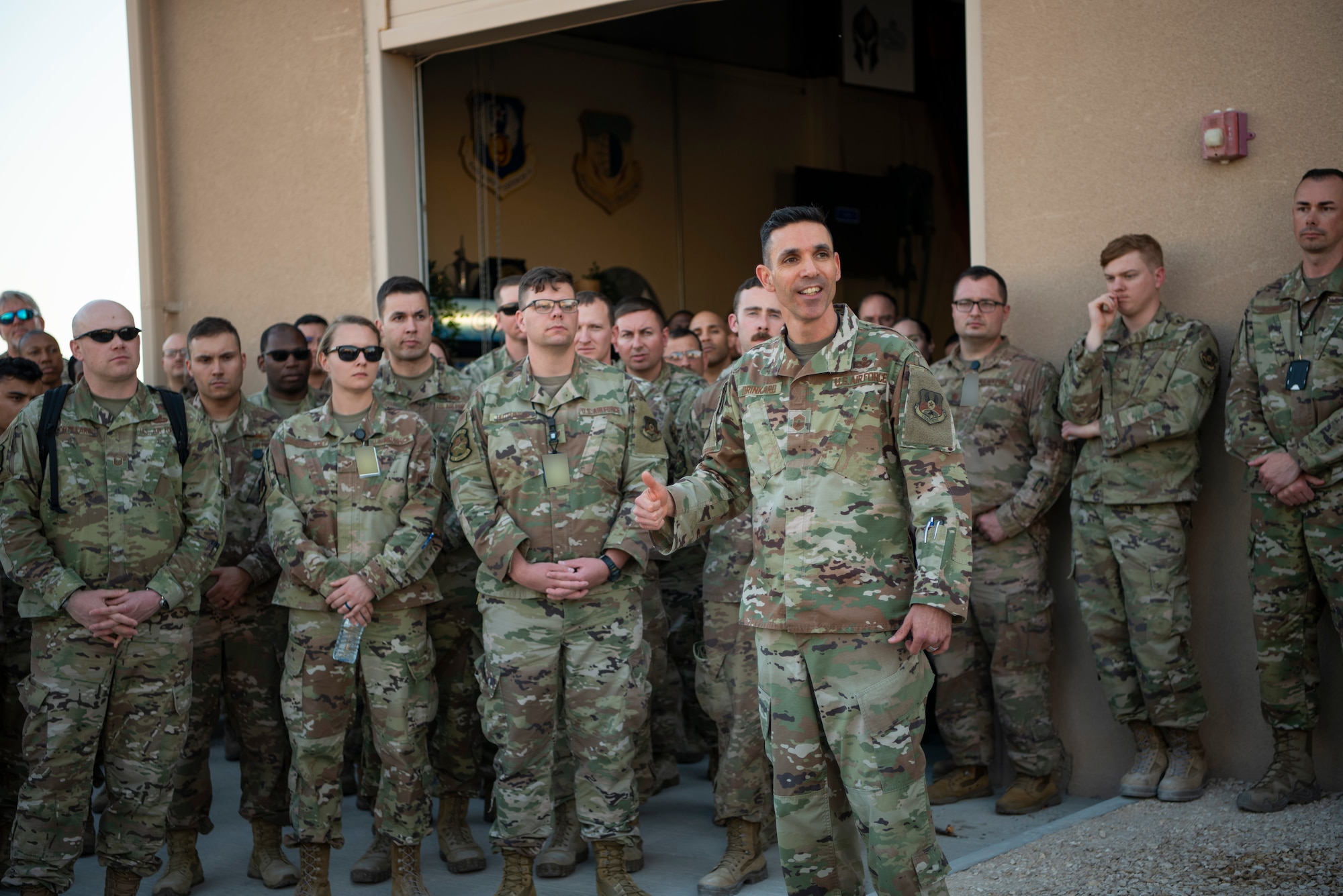 U.S. Air Force Chief Master Sgt. Shawn Drinkard, U.S. Air Forces Central Command command chief, speaks with AFCENT Airmen outside of the combined air operations center at Al Udeid Air Base, Qatar, March 6, 2020.