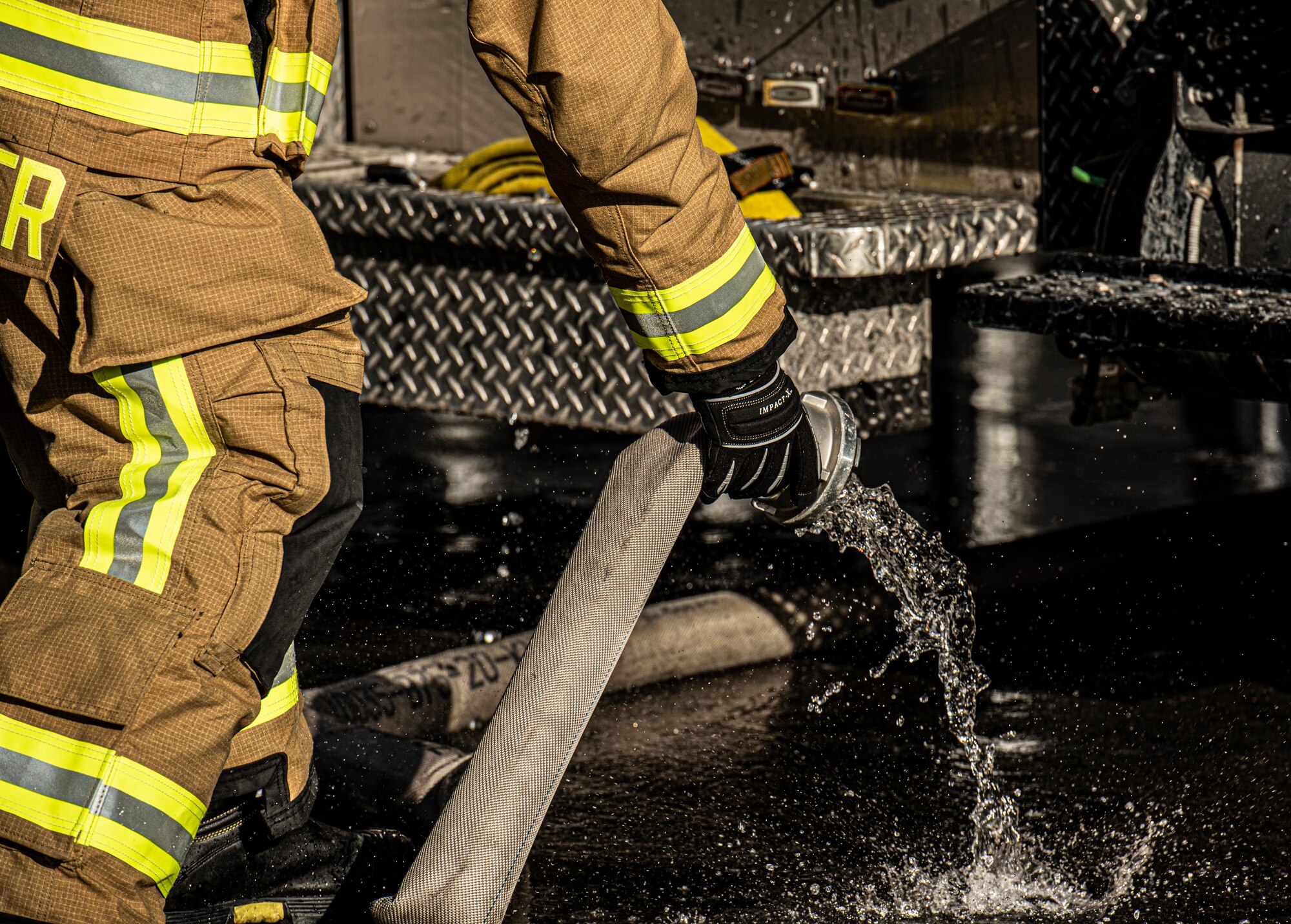 U.S. Air Force Airman 1st Class Jackson Bird, 86th Civil Engineer Squadron Fire and Emergencies firefighter, unhooks a water hose from a firetruck in Otterberg, Germany, March 23, 2020.