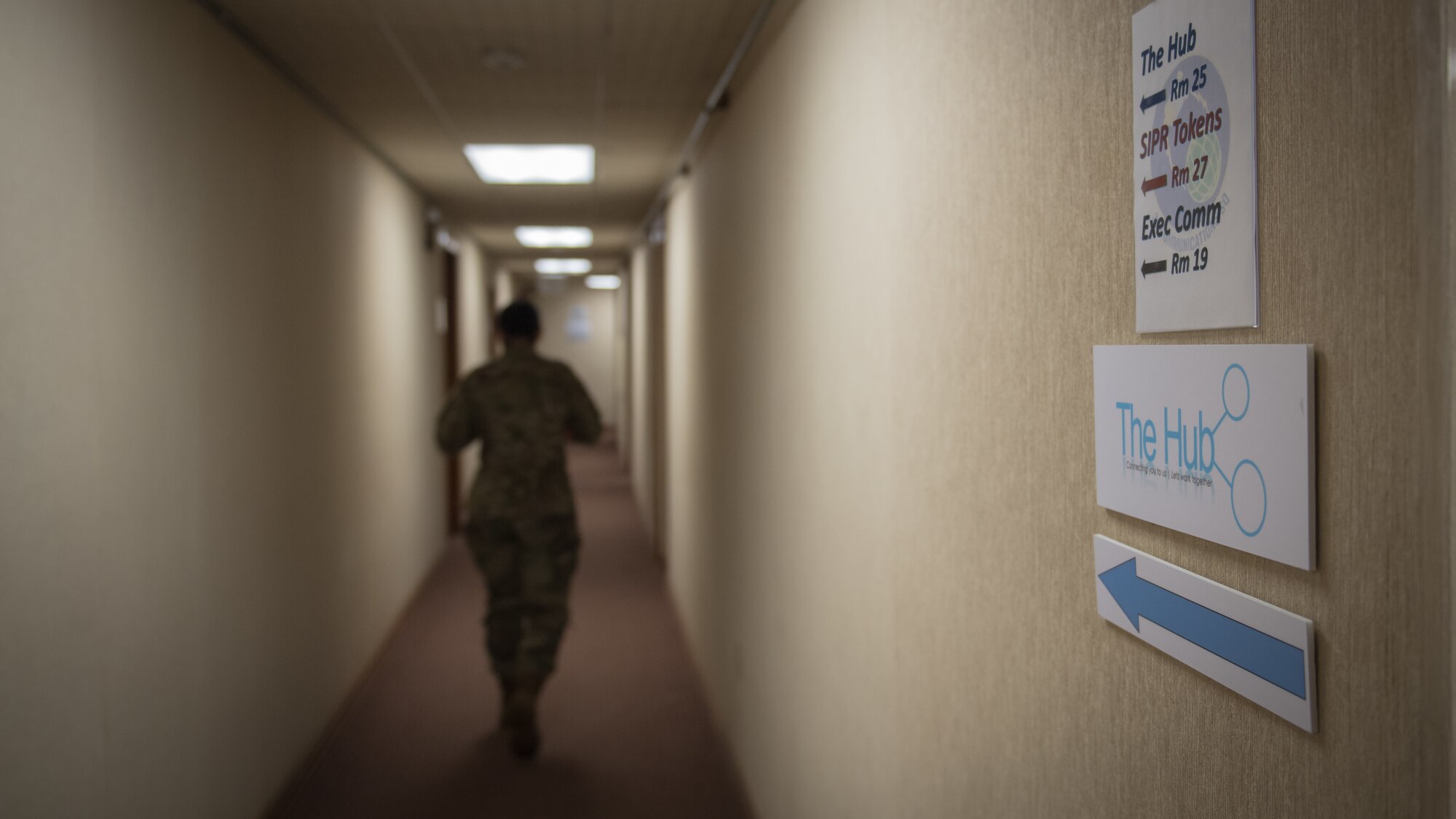 Tech. Sgt. Jessica Oliver, 2nd Communications Squadron base equipment control office NCO-in-charge, walks through the down a hallway at the 2nd CS on Barksdale Air Force Base, La., March 20, 2020. Oliver manages all IT hardware and software across the base. (U.S. Air Force photo by Tech. Sgt. Daniel Martinez)