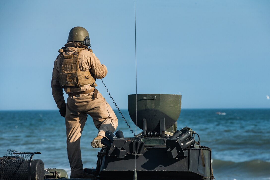 A U.S. Marine with 3rd Platoon, Bravo Company, 2d Assault Amphibian Battalion speaks through a radio while conducting a ship-to-shore event at Camp Lejeune, N.C., March 19, 2020. The annual training requirement was used to maintain and improve the unit’s readiness and proficiency while conducting amphibious operations. (U.S. Marine Corps photo by Lance Cpl. Patrick King)