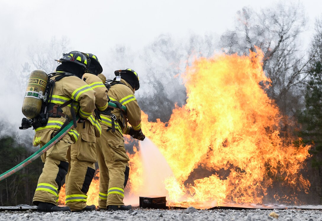 Arnold Air Force Base Fire and Emergency Services personnel attack a ground fire near an aircraft with a hand line while training, March 5, 2020, using a propane-fueled trainer brought to the base. The aircraft trainer uses propane to generate controlled fires in various locations in and around the mock fuselage. (U.S. Air Force photo by Jill Pickett)