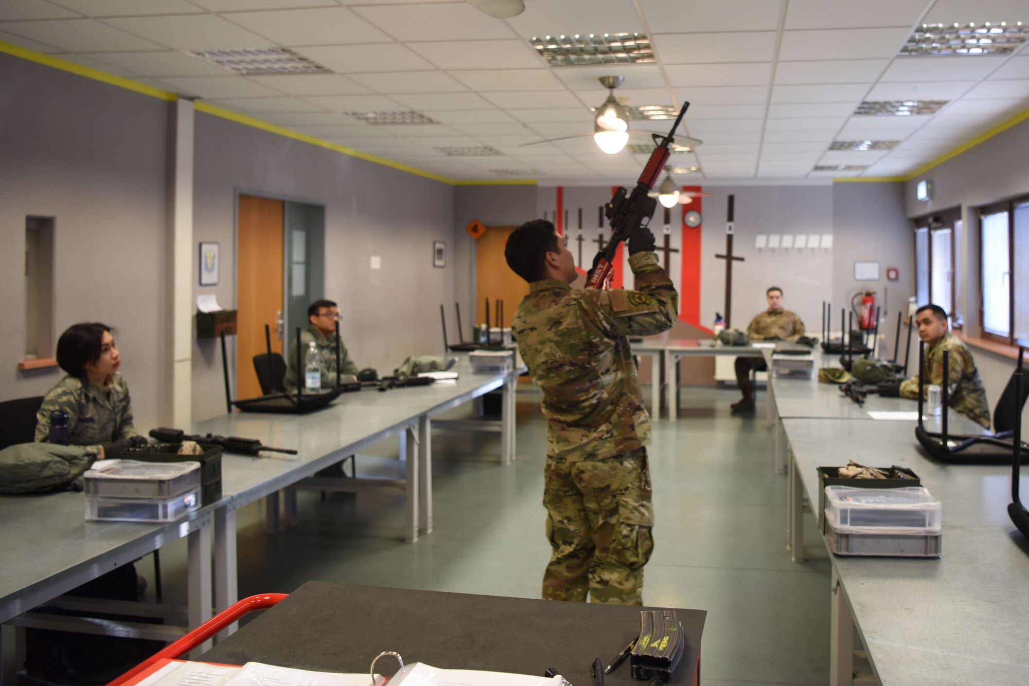 U.S. Air Force Senior Airman Francisco Torres, 569th U.S. Forces Police Squadron combat arms instructor, demonstrates arms safety on an M4 carbine assault rifle during a Combat Arms Training and Maintenance course.