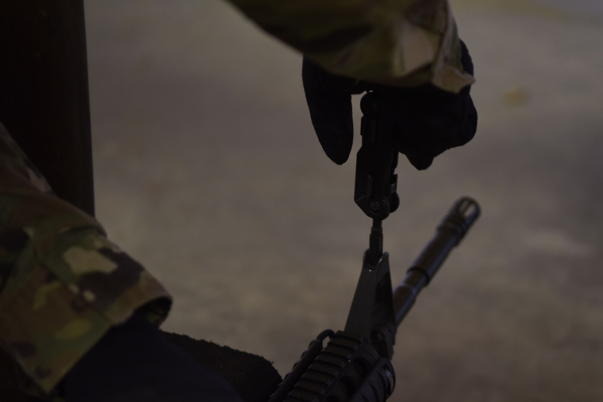 U.S. Air Force Senior Airman Francisco Torres, 569th U.S. Forces Police Squadron combat arms instructor, adjusts the firing sights on an M4 carbine assault rifle during a Combat Arms Training and Maintenance course.