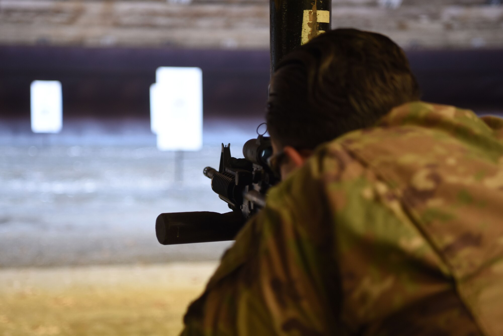 U.S. Air Force Senior Airman Alaire Osborn-Lief, 721st Aerial Port Squadron passenger service agent, aims an M4 carbine assault rifle during a Combat Arms Training and Maintenance course.