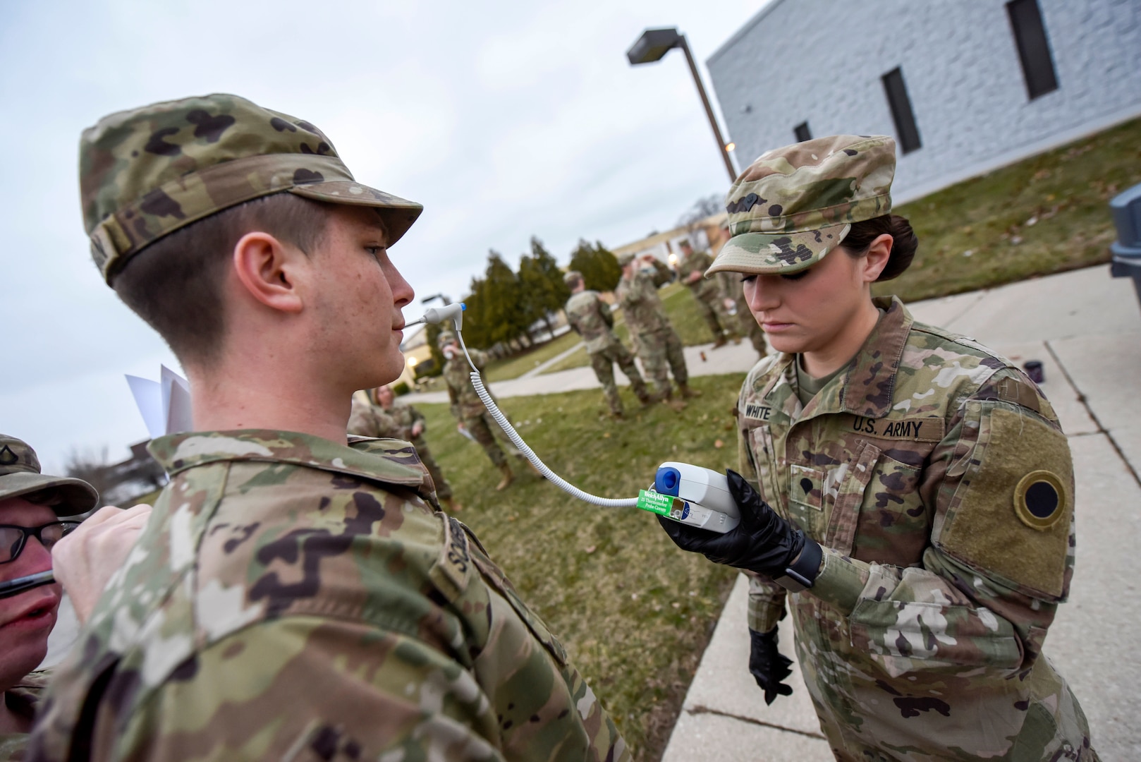 U.S. Army Spc. Kinnis White, assigned to the Ohio National Guard’s 1-148th Infantry Regiment, 37th Infantry Brigade Combat Team, checks the temperatures of Soldiers assigned to the regiment before assisting at the Toledo Northwestern Ohio Food Bank March 24, 2020. Nearly 400 Ohio Guard members were activated to support COVID-19 relief efforts.