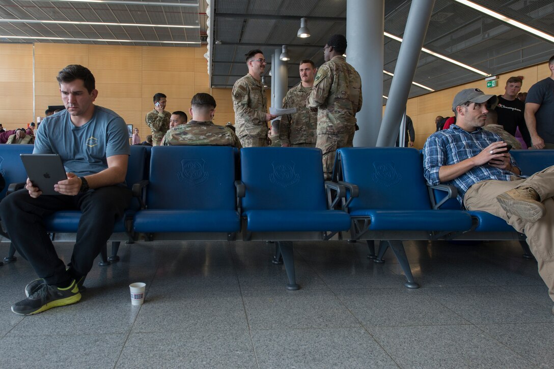 A picture of people sitting in a waiting room.