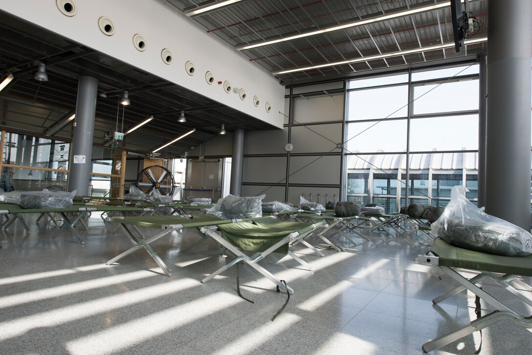 A picture of a room full of cots.