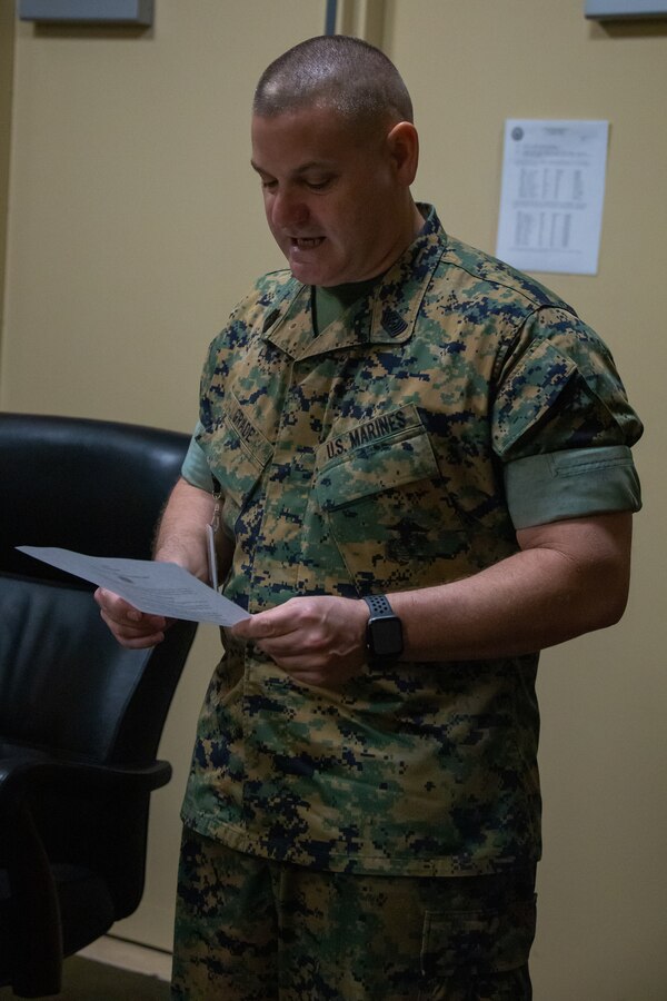 U.S. Marine Corps Sgt. Maj. Scott D. Grade, sergeant major of Marine Forces Reserve and Marine Forces North, reads the warrant for the promotion of Brig. Gen. Micheal S. Martin to the rank of major general on March 24, 2020 at Marine Corps Support Facility New Orleans. Maj. Gen. Martin, the current commanding general of 4th Marine Division, was in his home in Southwick, Massachusetts, and was promoted over the phone due to the COVID-19 travel restrictions and safety measures. MARFORRES and MARFORNORTH are safely continuing their support efforts to the total force during this time. (U.S. Marine Corps Photo by Lance Cpl. Samwel Tabancay)