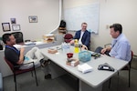 NSWC PHD Division Manager Richard Watanabe (left), and Alan Jaeger (right), manager of NSWC PHD’s Office of Research and Technology Applications, chat with Trevor Harding, materials engineering department chair from California Polytechnic University, San Luis Obispo, during his visit to the command on March 6. NSWC PHD recently signed an Educational Partnership Agreement with Cal Poly with the hopes of providing opportunities for recruitment, research, internships and more.