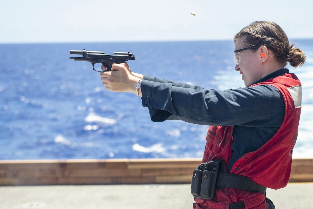 A sailor fires a weapon.