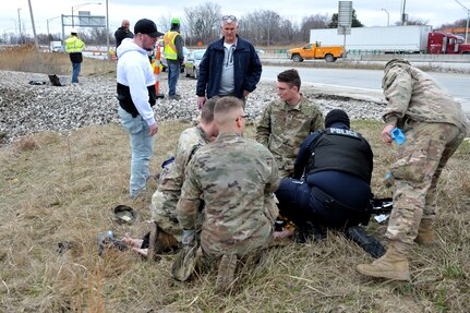 U.S. Army National Guard Soldiers, assigned to the Ohio National Guard’s HHC 1-148th Infantry Regiment – 37th Infantry Brigade Combat Team, assist after witnessing a single vehicle crash near Toledo, Ohio, March 23, 2020.
