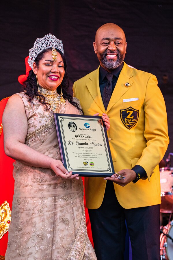 Elroy A. James, right, presents Dr. Chanda Macias, left, with an award for being this years Queen Of Zulu, during Lundi Gras at the Riverfront Park, New Orleans, February 24, 2020. The Zulu organization hosts the Zulu parade each year on Mardi Gras Day and is New Orleans' largest predominantly African-American carnival organization. (U.S. Marine corps photo by Lance Cpl. Samwel Tabancay)