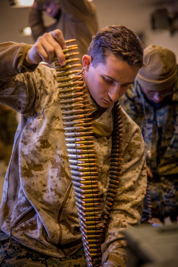 Cpl. Jonathan L. Tilas, an ammunition technician with 7th Engineer Support Battalion, 1st Marine Logistics Group, prepares 7.62 mm ammunition before a machine gun range at Fort Greely, Alaska, Feb. 22, 2020, in preparation for exercise Arctic Edge 2020. Arctic Edge provides high quality and effective training in extreme cold-weather conditions which enables Marines to navigate, communicate, and sustain themselves to be effective in arctic environments. (U.S. Marine Corps photo by Lance Cpl. Jose Gonzalez)
