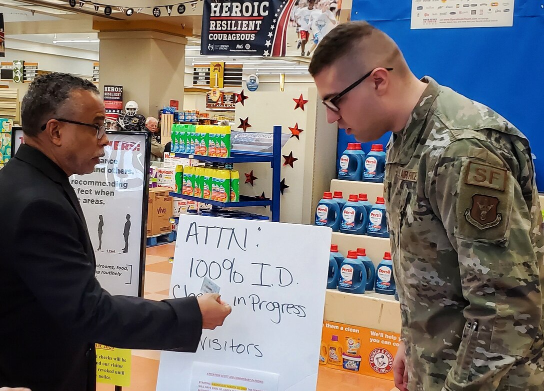 Senior Airman Austen Boettcher, from the 932nd Security Forces Squadron, volunteers to check IDs at the Scott Air Force Base commissary March 20, 2020. (U.S. Air Force photo by Christopher Parr)