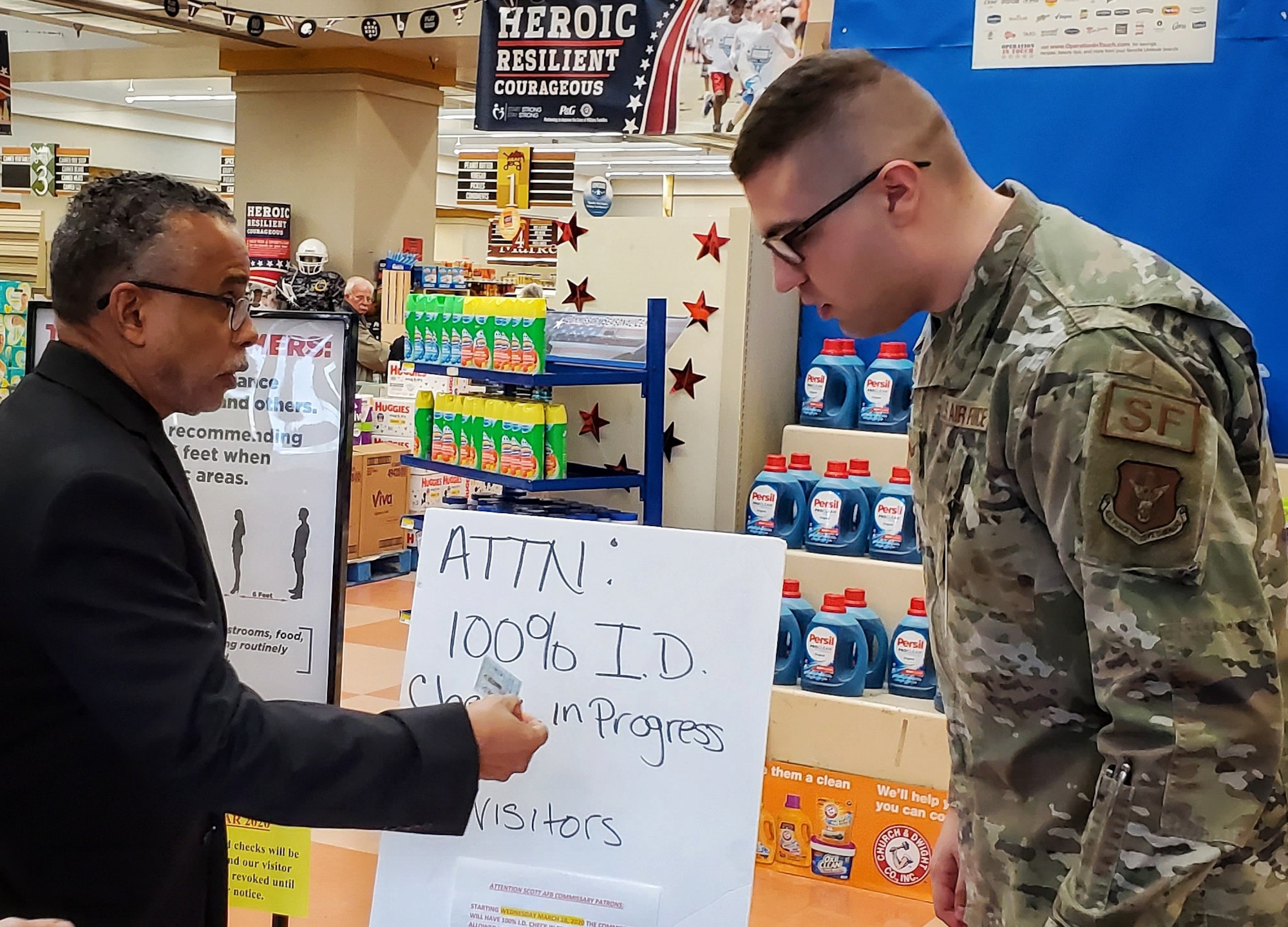 Senior Airman Austen Boettcher, from the 932nd Security Forces Squadron, volunteers to check IDs at the Scott Air Force Base commissary March 20, 2020. (U.S. Air Force photo by Christopher Parr)