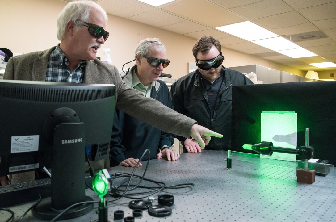 Dr. David Plemmons, left, a senior scientist with the Arnold Engineering Development Complex (AEDC), speaks about the use of a continuous wave laser Jan. 13, 2020, in the Test Technology, Analysis and Evaluation Branch’s Laser Laboratory at Arnold Air Force Base, Tenn. The Branch develops measurement and diagnostic techniques utilizing the lasers in the lab that can then be fielded in AEDC test cells.  Also pictured are Dr. Joe Wehrmeyer, center, technical advisor to the Technology Section of the Branch, and Joe Braker, an optical engineer. (U.S. Air Force photo by Jill Pickett)