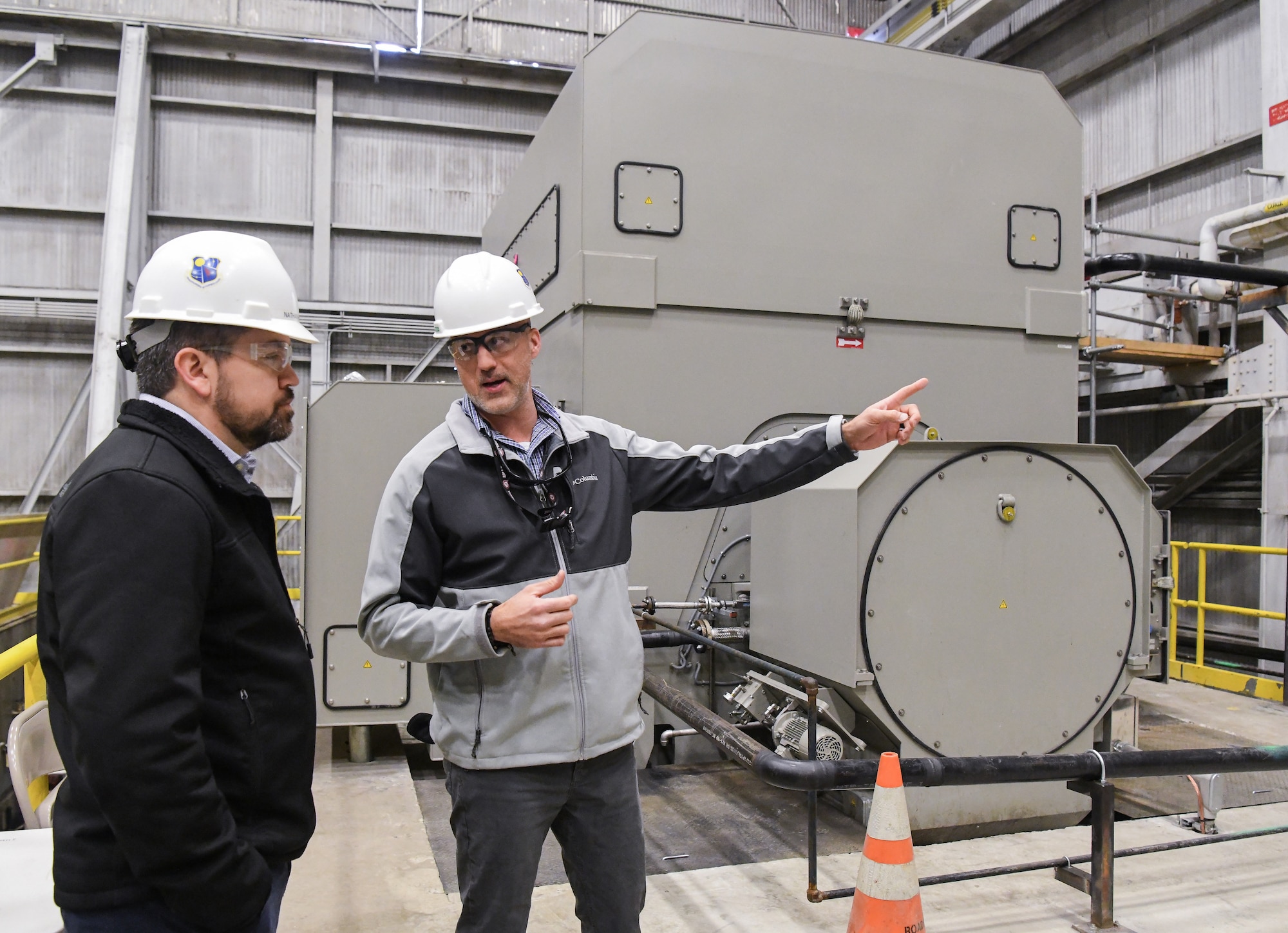 Joseph Baxter, right, an AEDC project manager, talks about A Plant Exhauster Motors improvements being completed under the Service Life Extension Program (SLEP), seen here Feb. 13, 2020, at Arnold Air Force Base, Tenn. Also pictured, Nathan Harrison, former SLEP manager for the Capital Improvements Branch. (U.S. Air Force photo by Jill Pickett)
