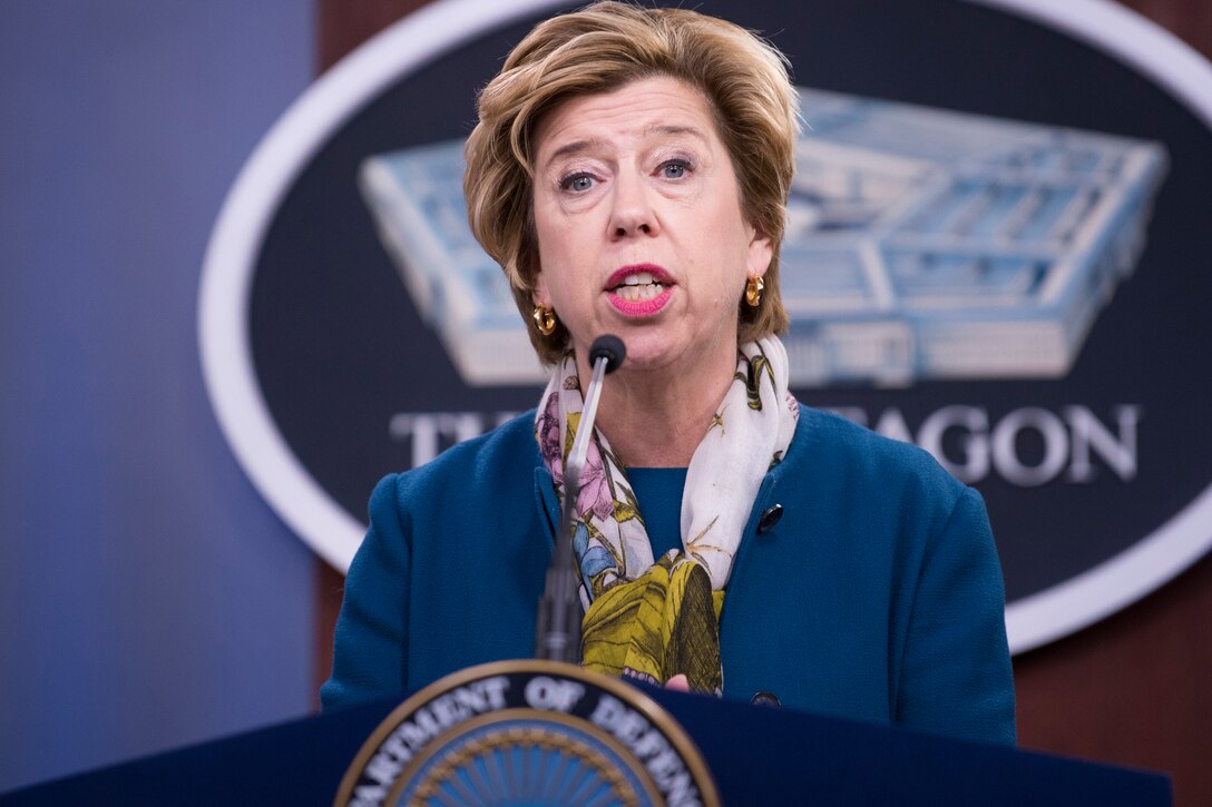 A woman speaks into a microphone.