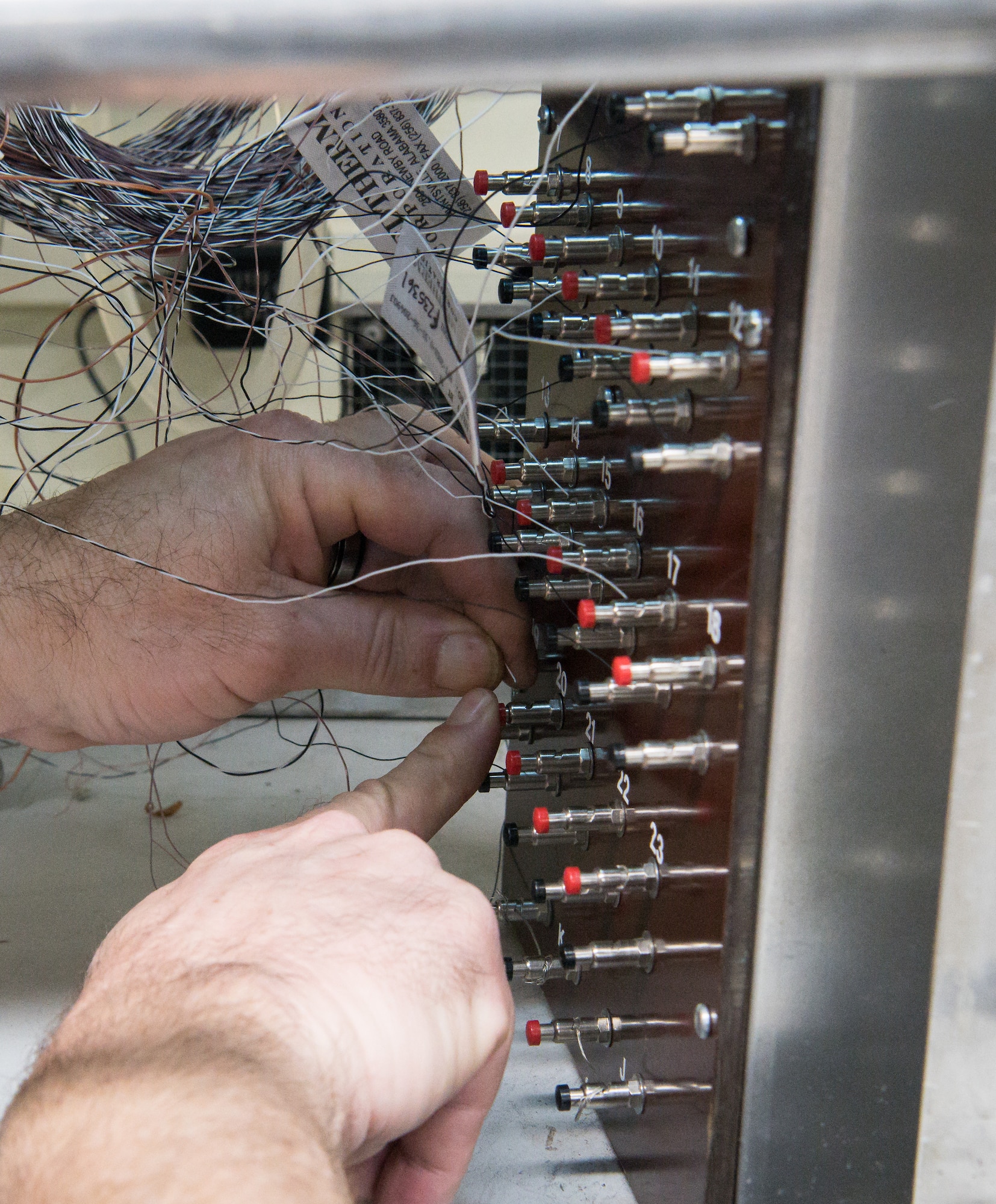 Brian Anderson, an instrumentation specialist, connects wires from a Schmidt-Boelter heat flux gauge to a machine used to calibrate the gauges Jan. 15, 2020, in the Aerothermal Calibration Laboratory at Arnold Air Force Base, Tenn. (U.S. Air Force photo by Jill Pickett)