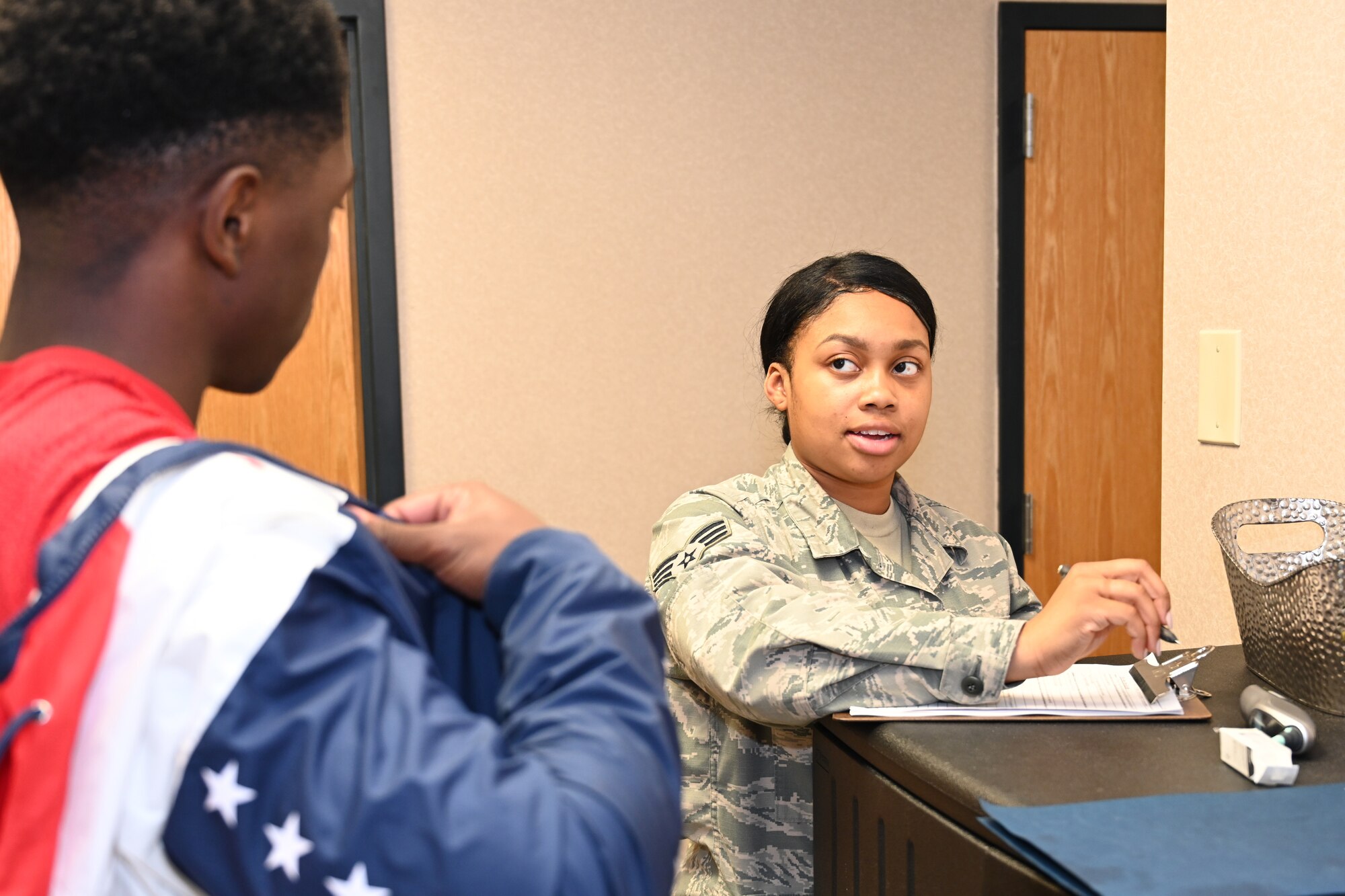 Photo of Airman administering screening.