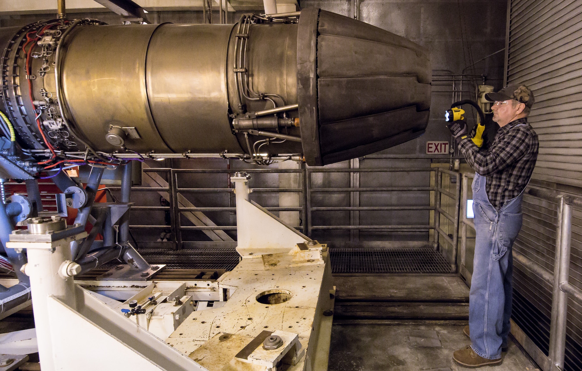 Stan Freeze, an outside machinist, inspects the tail of a F404 engine Jan. 10, 2020, in a sea level test cell at Arnold Air Force Base, Tenn.  The engine is being prepared for use as a testbed by the Arnold Engineering Development Complex Technology, Analysis and Evaluation Branch. (U.S. Air Force photo by Jill Pickett)