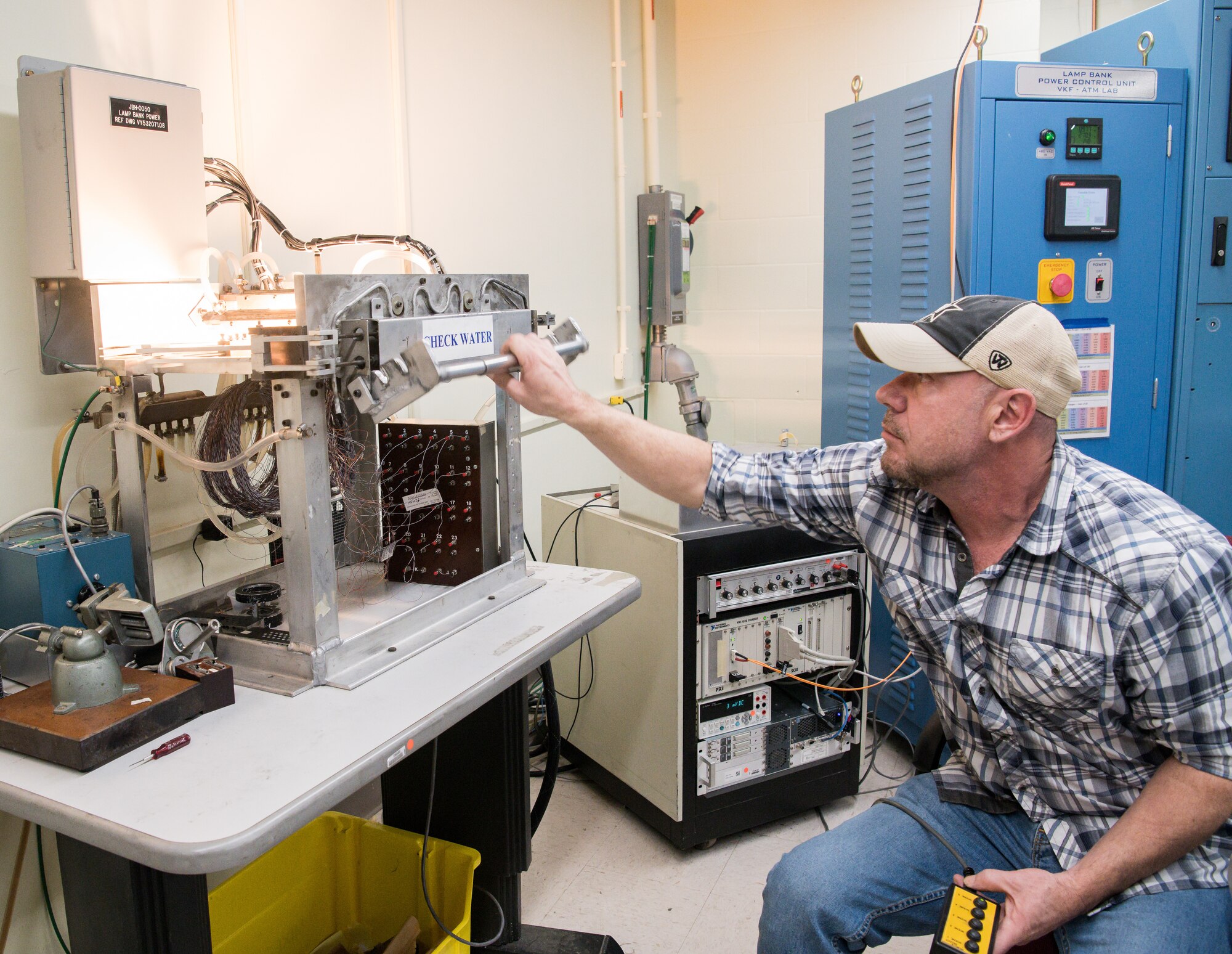 Brian Anderson, an instrumentation specialist, demonstrates the use of a machine to calibrate Schmidt-Boelter heat flux gauges Jan. 15, 2020, in the Aerothermal Calibration Laboratory at Arnold Air Force Base, Tenn. (U.S. Air Force photo by Jill Pickett)