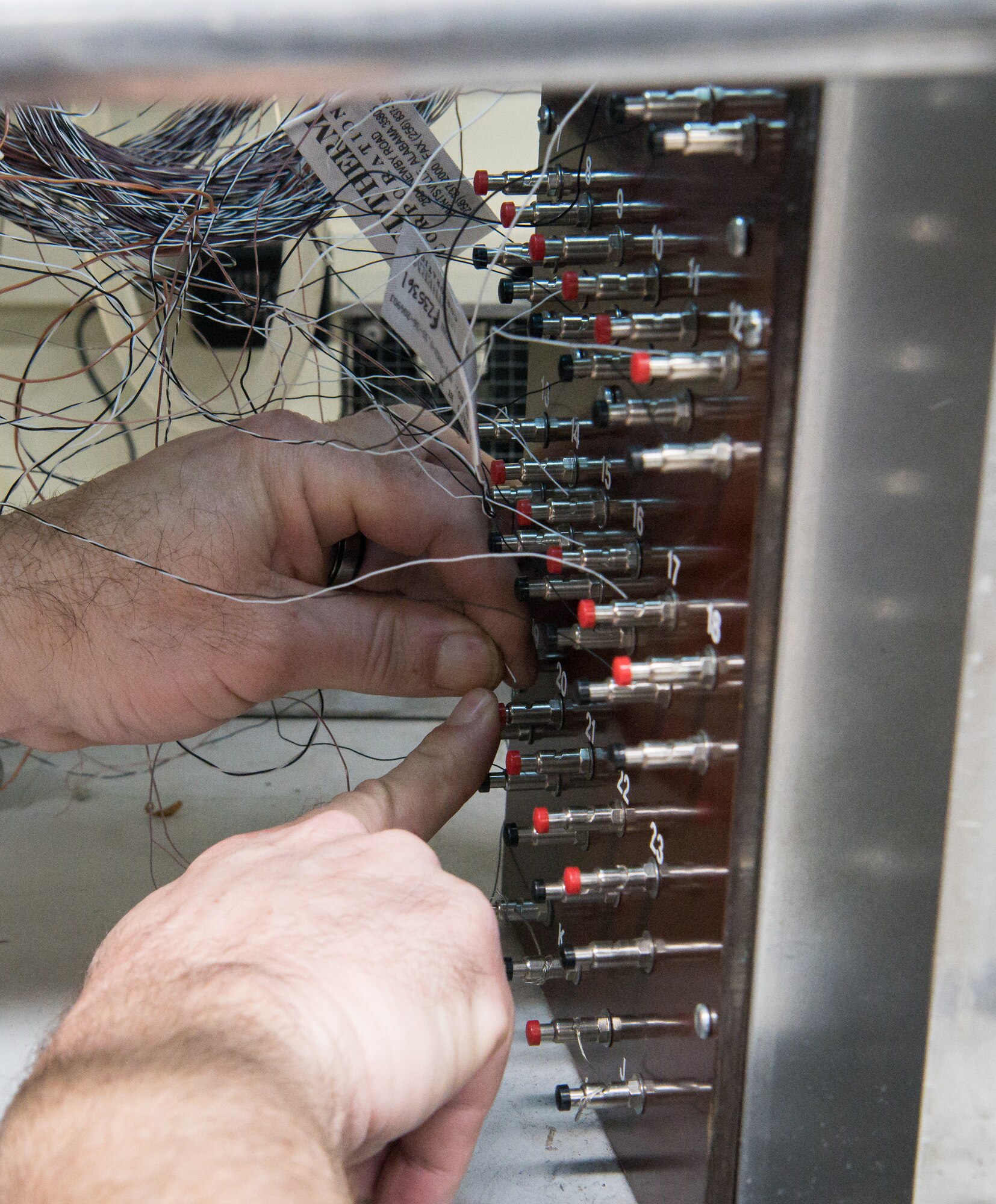 Brian Anderson, an instrumentation specialist, connects wires from a Schmidt-Boelter heat flux gauge to a machine used to calibrate the gauges Jan. 15, 2020, in the Aerothermal Calibration Laboratory at Arnold Air Force Base, Tenn. (U.S. Air Force photo by Jill Pickett)