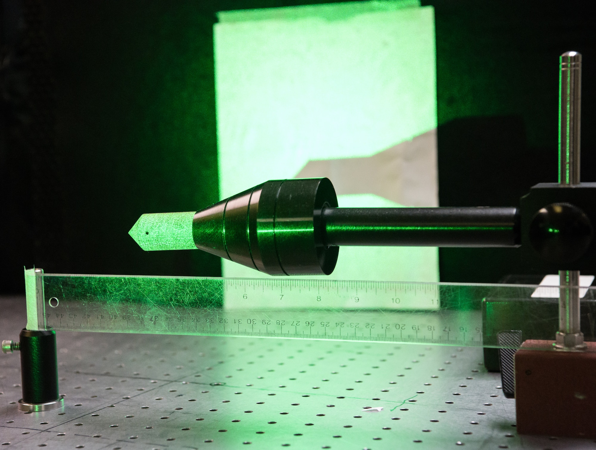 A continuous wave laser burns a hole into a sample Jan. 13, 2020, in the Laser Laboratory at Arnold Air Force Base, Tenn. The Arnold Engineering Development Complex (AEDC) Test Technology, Analysis and Evaluation Branch develops measurement and diagnostic techniques utilizing the lasers in the lab that can then be fielded in AEDC test cells. (U.S. Air Force photo by Jill Pickett)